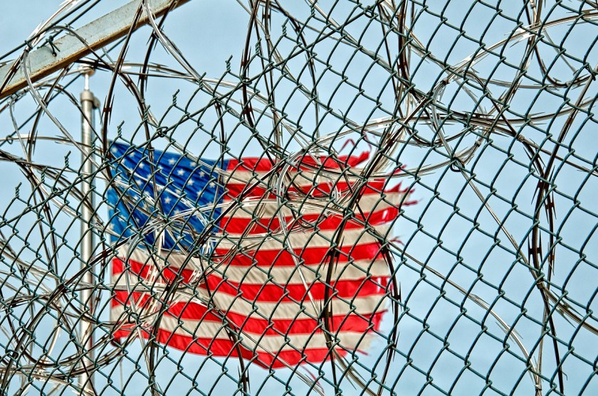us flag behind fence